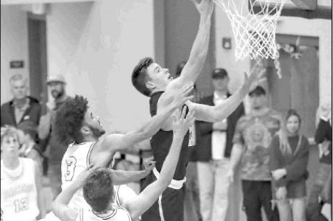 KHS JUNIOR Matthew Stone lays in a bucket during his team’s season-opening win at Newcastle last week. Stone had 17 points and 15 rebounds for second-ranked KHS.             [Photo by Chris                           Simon/www.simon-sports-photos.s